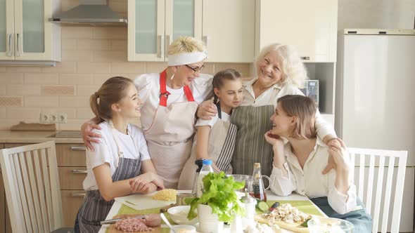 Friendly Kind Family Having Good Time Together at Home in Kitchen Smiling