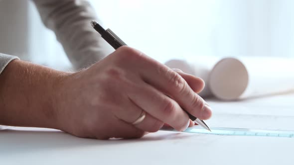 Close-up of an architect's hands. Professional real estate designer alt