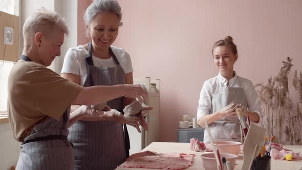 Three Women Working in Ceramic Workshop alt