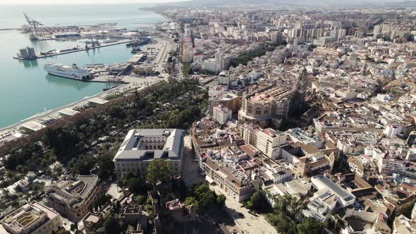 Malaga cityscape view from above, Aerial Orbiting from harbor to downtown. Spain