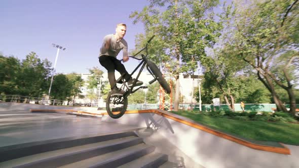 BMX Rider Doing Tricks in Extreme Park During Sunset Slow Motion alt