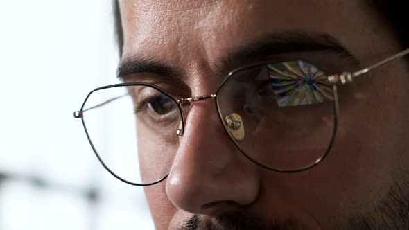 Close-up Portrait of a Young European Man with Glasses, the Reflection of Images is Working  alt