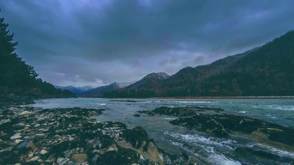 Time Lapse Shot of a River Near Mountain Forest. Huge Rocks and Fast Clouds Movenings alt