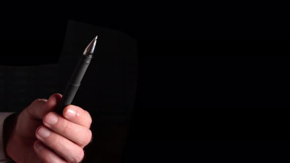 Pen For Writing In Hand On Black Background