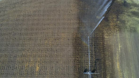 Aerial view of irrigation sprinkles used in harvested field  alt