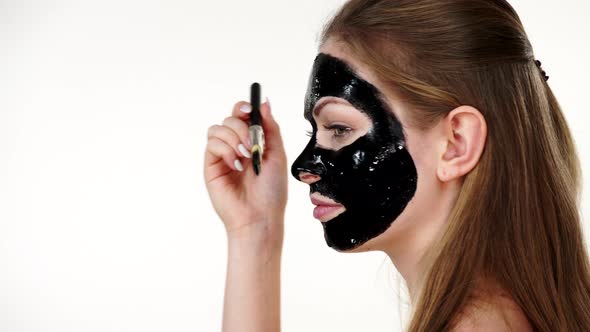 Girl with Black Carbo Peel Off Mask on Face