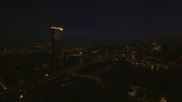 Aerial Panoramic Night Shot of One Manhattan Square Apartment Building with Illuminated Rooftop and alt