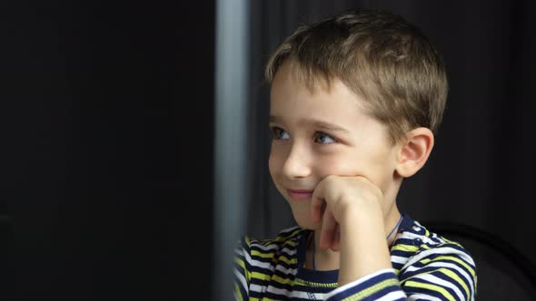 Happy Child Spends Time at the Computer alt