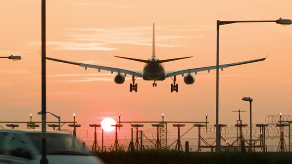 Passenger plane landing at sunset