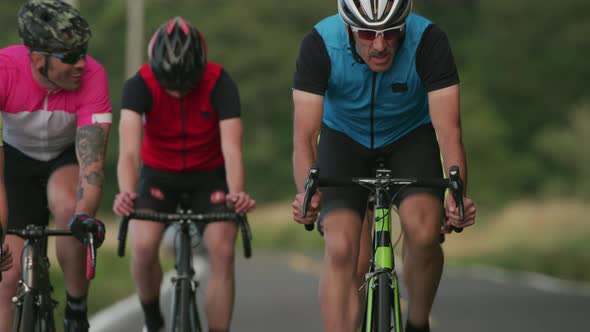 Tracking shot of a group of cyclists on country road.  Fully released for commercial use.