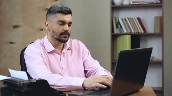 Old-Fashioned Writer Can't Abandon His Typewriter, Typing Book in Two Copies alt