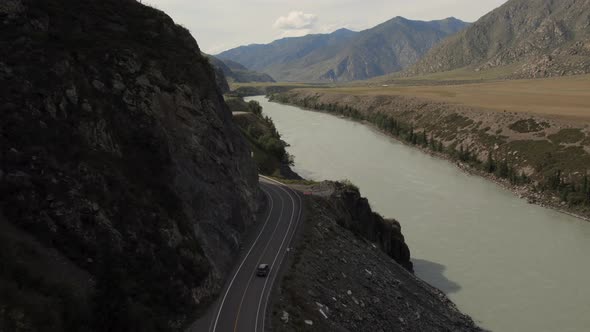 Mountains valley of Altai with traffic cars on Chuya highway and Katun river