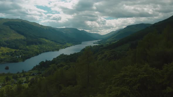 Aerial Drone Balquhidder Loch Voil Over Trees Dramatic Cloudy 25p alt