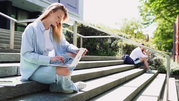 Smiling Girl Student Using Laptop Computer Outdoor in University Campus alt
