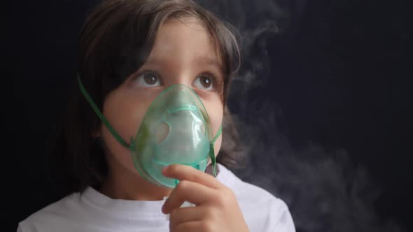 Boy Child Breathes Inhalation Through a Mask is Treated for Allergies alt