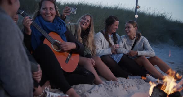 Beautiful Ladies Sitting By the Bonfire By the Beach alt