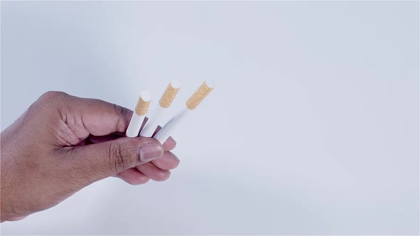 Hand Holding 3 Cigarettes alt