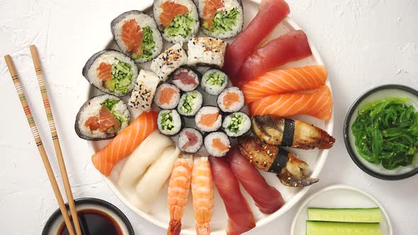 Various Sushi Rolls Placed on Round Ceramic Plate alt