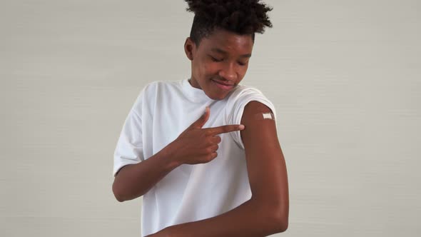 African American Teenager Showing COVID19 Vaccine Bandage Merrily alt