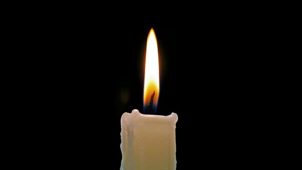 Burning Candle On A Black Background