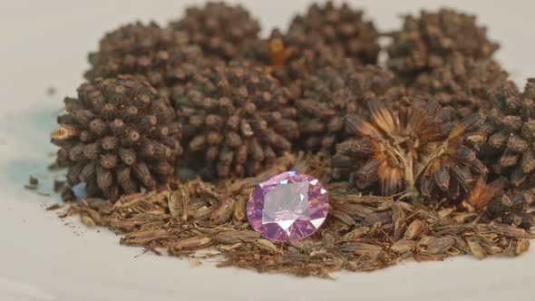 Pink Amethyst Diamonds In A Pile Of Kratom Seeds. alt
