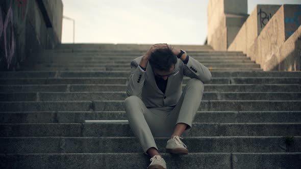 Tired Exhausted Overworked Businessman.Overwhelmed Businessman Working Outdoors.Man Sitting On Steps alt