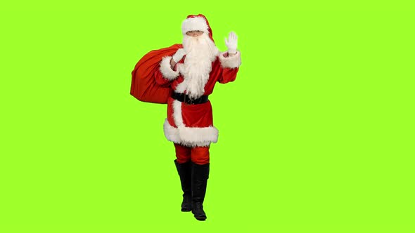Santa Carrying Gifts in Sack and Waving Greetings on Green Background