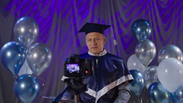 Male Dean of University Congratulates Students on Graduation and Presents Diplomas Online alt