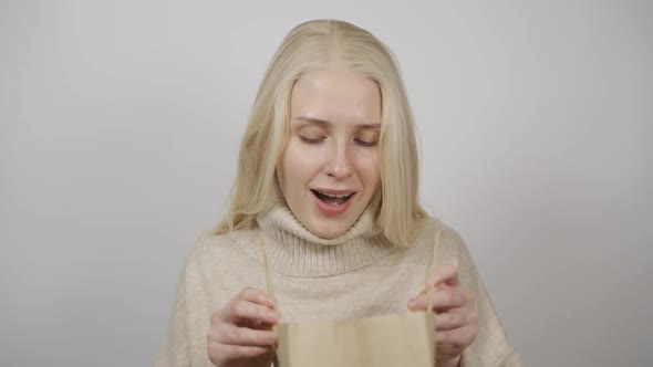 Happy Woman Open Delivery Internet Shopping Box Smiling Woman Looking Inside Ecommerce Clothes alt