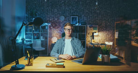 Time Lapse of Blond Guy Businessman Sitting at Desk in Office Late at Night alt