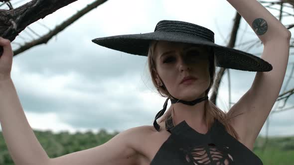 Portrait Of Pretty Blonde In Black Hat. Face With Professional Makeup. alt