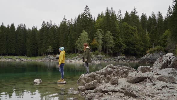 Hikers at Fusine lake, Italy alt