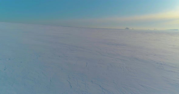 Aerial View of Cold Winter Landscape Arctic Field Trees Covered with Frost Snow Ice River and Sun alt