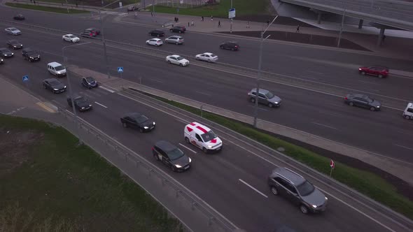 Lowangle Drone Flight Over a Massive Intersection During Early Evening Rush Hour with Cyclists