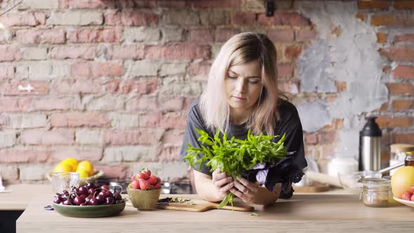 Cheerful Blondie Holds Fresh Mint Leaves