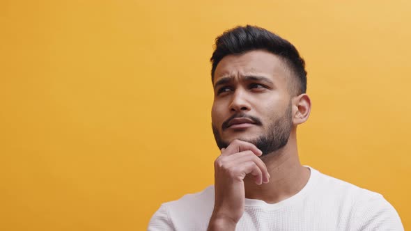 Indian Guy Looking Up And Thinking  Concept Of Thinking Of An Idea Or Solution alt