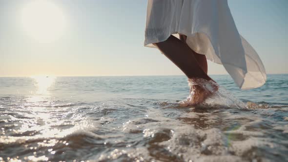 Barefoot of Girl Going on Sandy Shore with Waves alt
