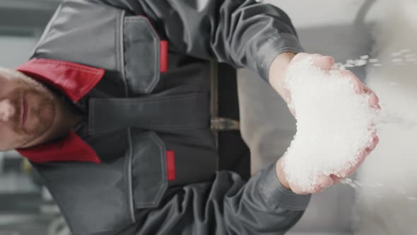 Workman With Handful Of Polypropylene Granules alt