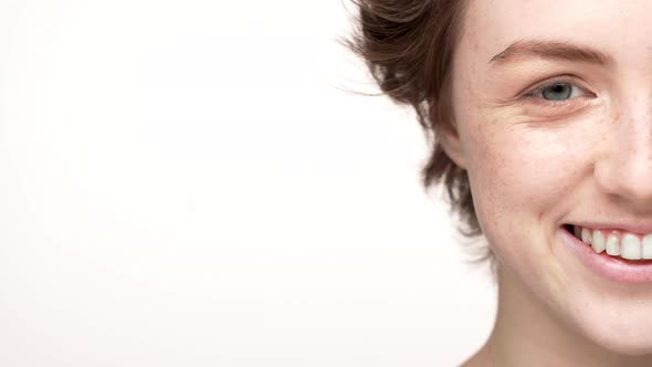Halfside Portrait of Joyful Woman with Freckle and Short Hair Looking on Camera with Smile Isolated alt