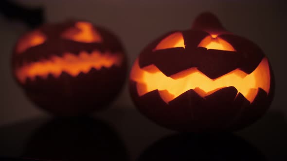 sinister pumpkins on Halloween, bat in the background alt