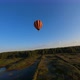 Black and orange hot air balloon floating above lake - VideoHive Item for Sale
