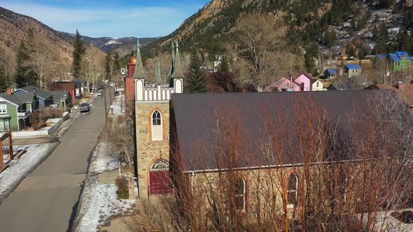 Aerial orbit of a gothic design church in a small town in the United States - drone shot alt