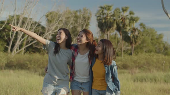 Young Asian woman looks to view the mountain and having fun together a summer traveling.