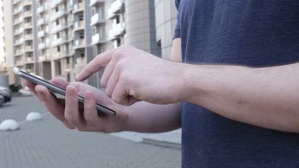 Young Man Using Smartphone alt