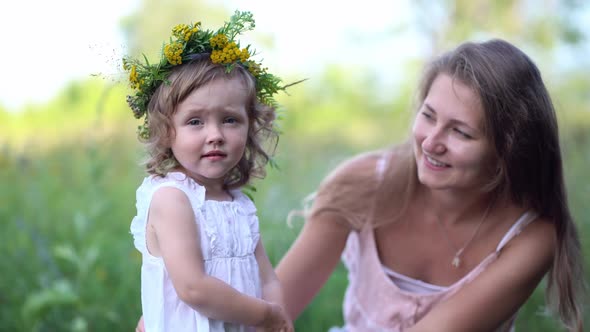 Happy Mother and Daughter with the Flower Wreath alt