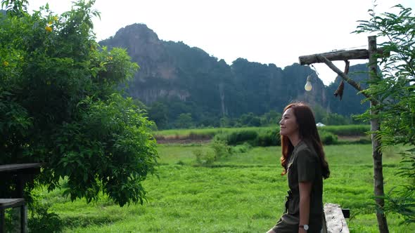 A beautiful woman looking at a beautiful nature and mountains view