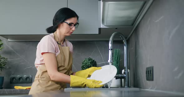 Housewife Brunette Lady Washing Dishes at Kitchen Everyday in Modern Interior Style Kitchen alt