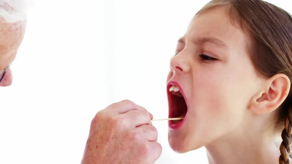 Male doctor examining a patient alt