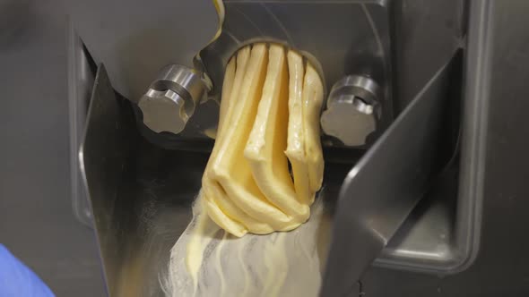 Producing Yelow Ice Cream Flavors and Comes Out of the Nozzle Down