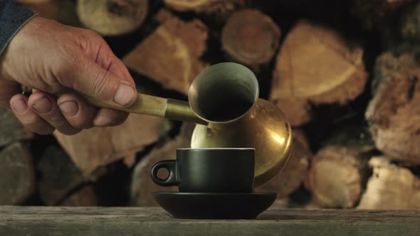 Tradition oriental coffee. Coffee is poured into a black mug made of copper cezve alt
